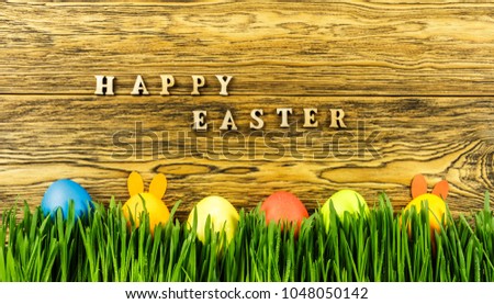 Hidden Easter Bunny in the grass and eggs. happy Easter. Ready greeting card design.