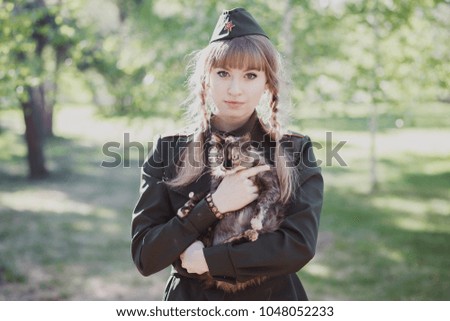 girl in uniform holds a cat