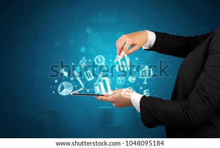 Elegant hand holding tablet with chalk drawn social media symbols above

