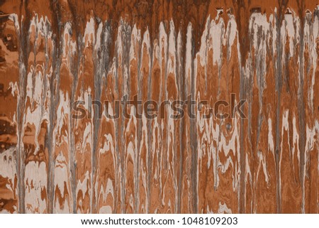 Orange wet abstract paint leaks and splashes texture on white watercolor paper background. Natural organic shapes and design.