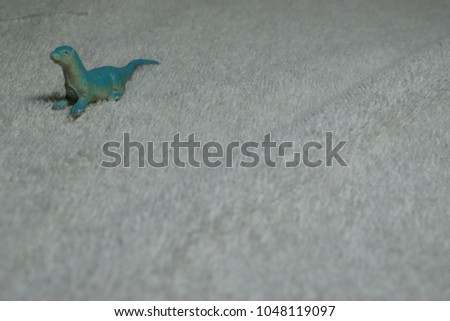 Blue otter toy on white cloth.