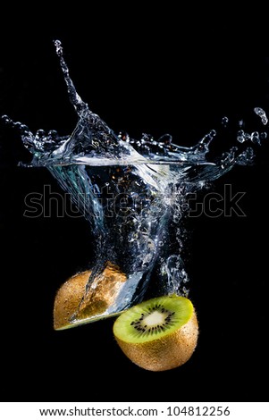 Splashing kiwi fruit on the water