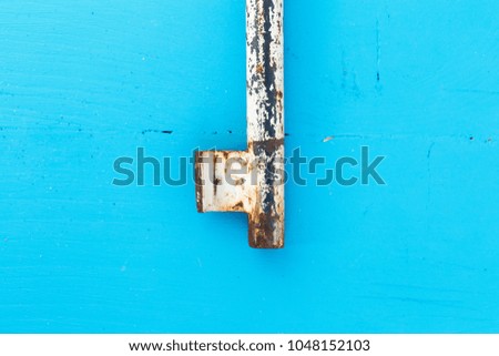 antique  old key on blue rustic wood background 
