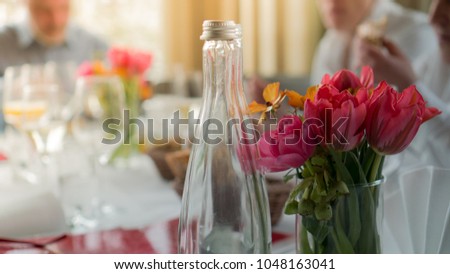 festive table with glasses and tulips