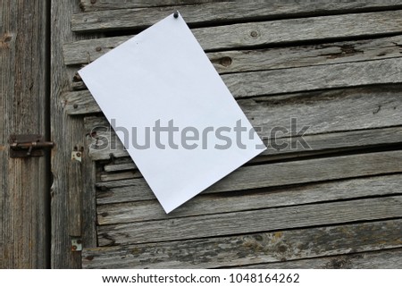 Close-up of one blank old vintage paper sheet with adhesive tape on weathered wooden background