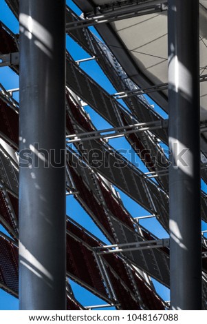 Close-up photograph of abstract architecture fragment. Composition with geometric structure in black and blue sky.