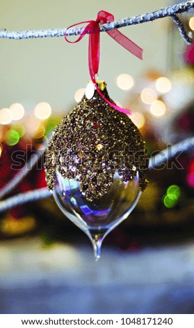 brown glittery beaded unique glass teardrop christmas holiday ornament hanging close up bokeh