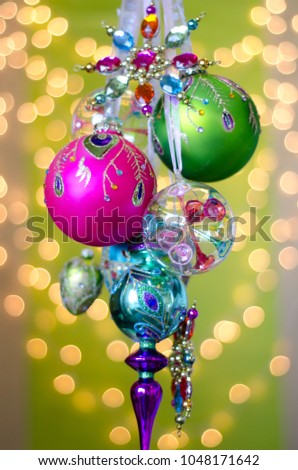 colorful hand painted glittery christmas ornaments on green decor christmas holiday close up