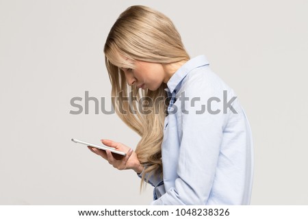 Close up portrait of young Caucasian woman looking and using smart phone with scoliosis, side view/Rachiocampsis/Kyphosis curvature of the spine/Incorrect posture, scoliosis, 
orthopedics concept Royalty-Free Stock Photo #1048238326
