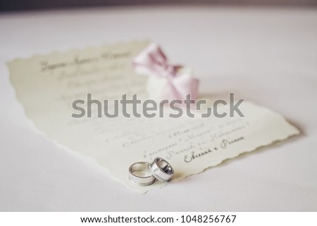 Wedding invintation letter with rings macro. Pastel vintage tonning. 