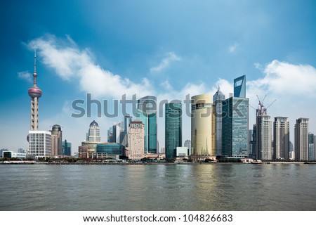 shanghai lujiazui financial center with huangpu river against a blue sky