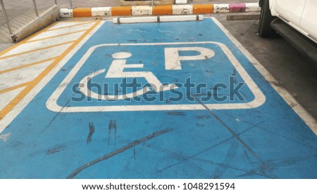 wheelchair sign parking on ground.