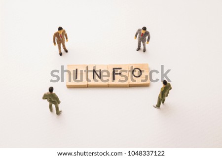 Miniature figures businessman : meeting on info letters by wooden block word on white paper background, in concept of business and corporation.
