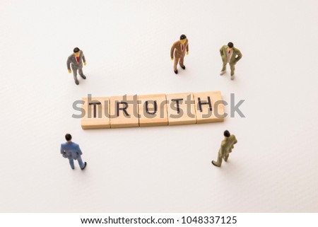 Miniature figures businessman : meeting on truth letters by wooden block word on white paper background, in concept of business and corporation.