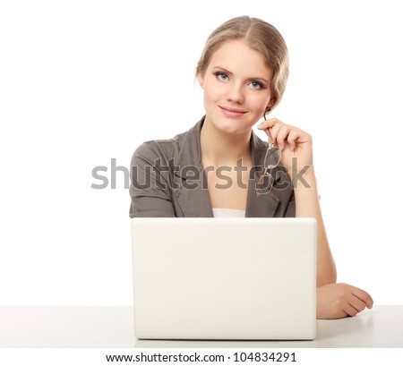 A portrait of a businesswoman sitting at a desk with a laptop