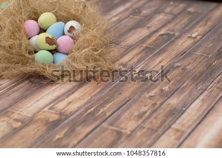 Easter image with Colorful Egg Chocolates on the Nest with Copy Space