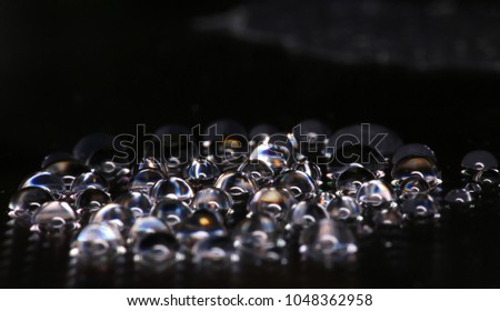 Water droplets gathered on a black background,background, texture