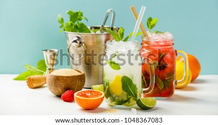 Fresh cocktail drinks with ice fruit and herb decoration. Alcoholic non-alcoholic drink-beverage. Mojito on blue background Royalty-Free Stock Photo #1048367083