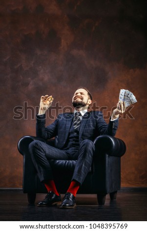 Businessman holding golden Bitcoin, Ticker Symbol BTC and dollar banknotes, finance money bitcoin concept.