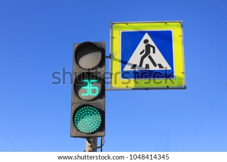 Green Traffic Light with Timer and Pedestrian Crosswalk Stop Signal on Blue Sky Empty Background. City Street Traffic Light Showing 36 Seconds, Crossing Street Caution, Safety and Warning Concept.
