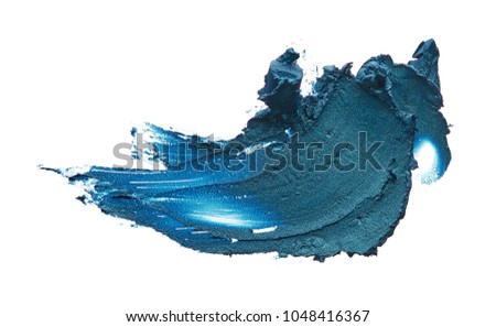 Navy blue creamy eye shadow isolated on white background. Texture of dark blue eye shadow on white. Smear of creamy eye shadow