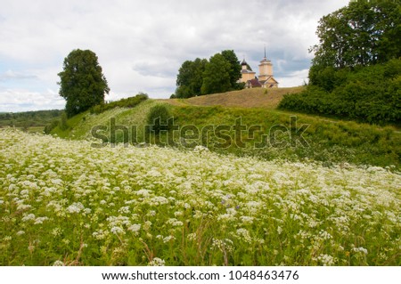 photo church on top of a green hill