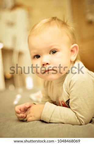 Little child standing with hands clasped together. Portrait.