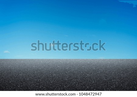 Empty asphalt road with blue sky background .
