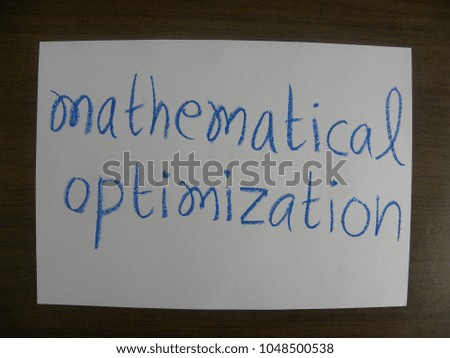 Text mathematical optimization hand written by blue oil pastel on white color paper