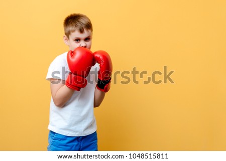 baby in Boxing gloves on wall background