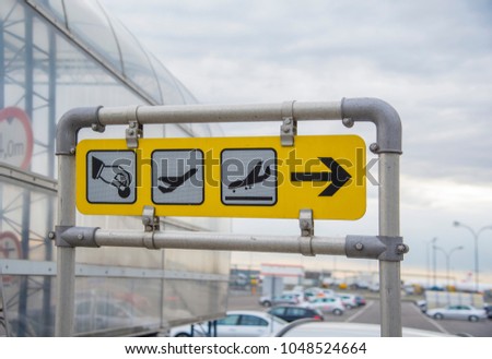 Airport signs departure and arrivals at the parking
