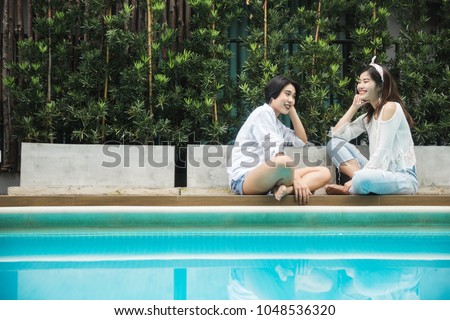 Young Asian female friends taking her vacation in the resort