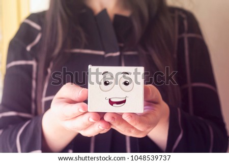 woman with beautiful hair holding white box with happy face emoticon