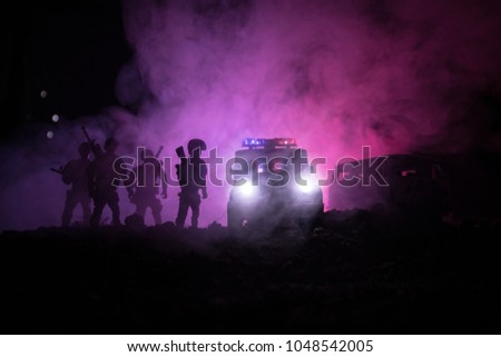 Anti-riot police give signal to be ready. Government power concept. Police in action. Smoke on a dark background with lights. Blue red flashing sirens. Dictatorship power