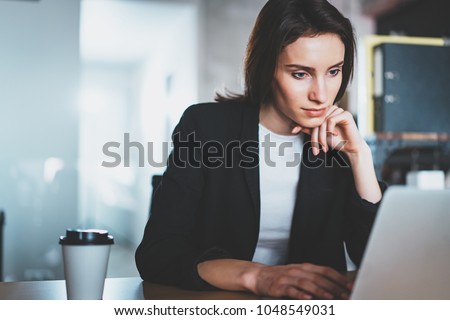 Young beautiful woman working at the modern office workplace. Horizontal. Blurred background