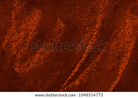 Colorful orange chalk pastel texture on black paper background. Abstract pencil strokes.