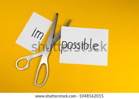 Impossible Is Possible Concept. card with the text impossible, cutting the word im so it written possible.  Royalty-Free Stock Photo #1048562015