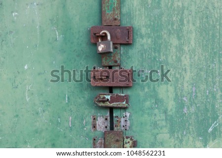 Old lock on the wood green door