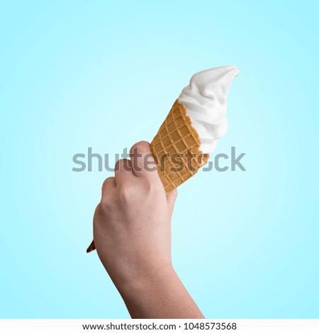 Woman is holding Ice cream in the cone on blue background.