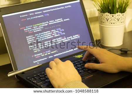 Web developer's workplace. Laptop with a note aside. Break after a hard work concept. Digital technology modern background. Code is created by myself.