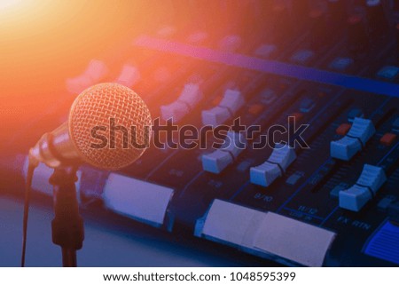 Microphone over the abstract blurred photo of conference hall or seminar room background, Dark background