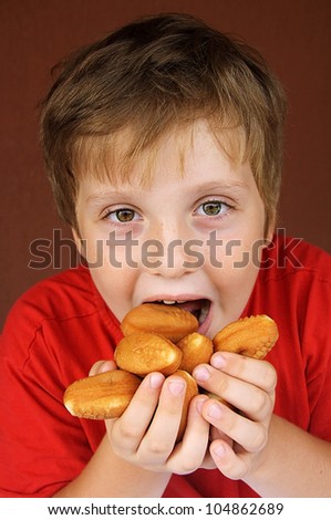 The boy eating tasty cakes