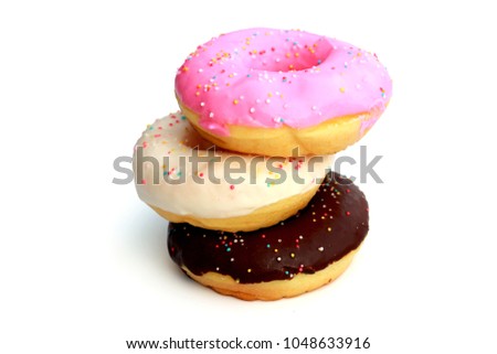 Three donuts are pink, white, Chocolate  with sprinkles isolated on white background Royalty-Free Stock Photo #1048633916