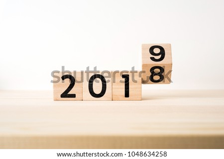 Business and design concept - surreal abstract geometric floating wooden cube with word " 2019 & 2018 " concept on wood floor and white background Royalty-Free Stock Photo #1048634258