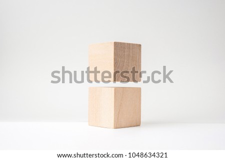 Design concept - 2 abstract geometric real wooden cube with surreal layout on white floor background and it's not 3D render