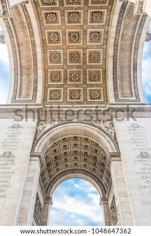 Paris, France, Ancient artwork, View of under  Arc de Triomphe (Arch of Triumph) at l'Etoile with cloudy blue sky with clouds in autumn background on a winter. Ancient artwork of paris france. Europe.