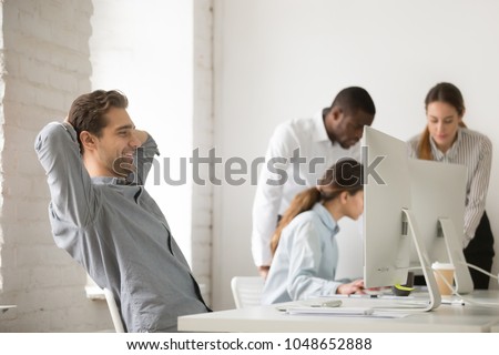Happy businessman holding hands behind head resting after finishing work on computer in multiracial office, company manager employee taking break for relaxing at workplace satisfied with good result Royalty-Free Stock Photo #1048652888