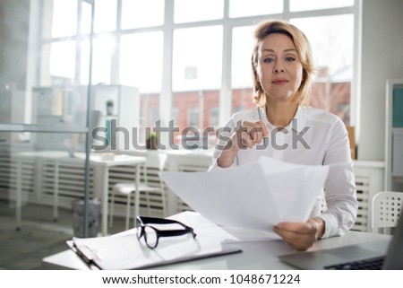 Portrait of businesswoman is going to sign some documents