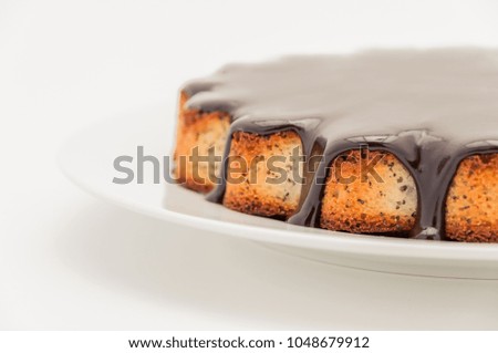 Half a cake of manga with chocolate covered in a plate on a whit