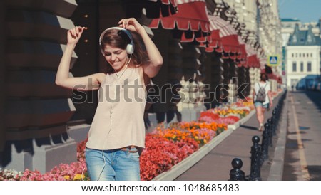 Dancing young woman in the street